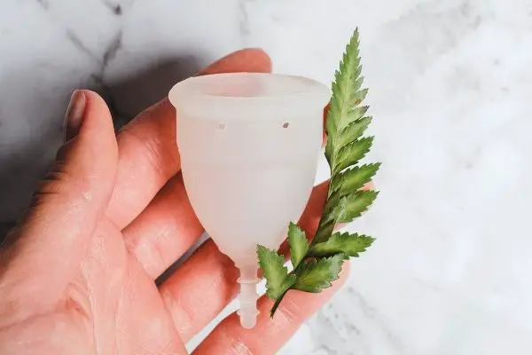 Person holding a menstrual cup