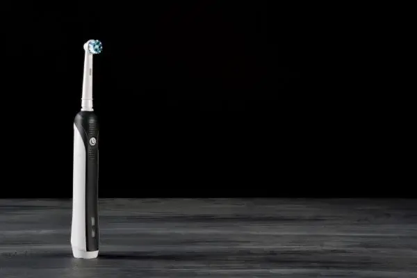 black and white electric toothbrush on gray and black table