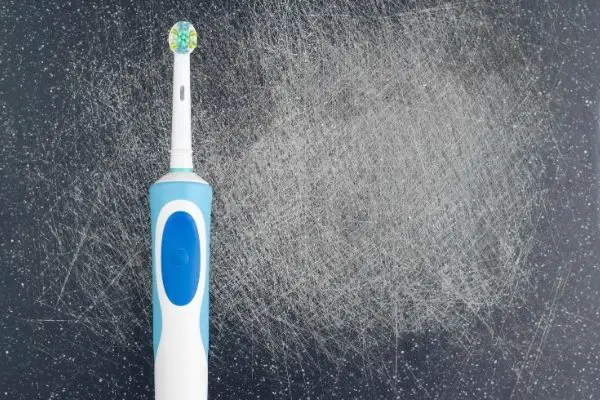 electric toothbrush on table with scratches
