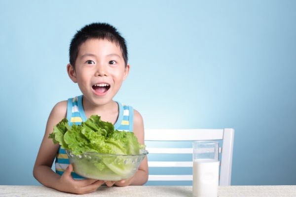 kid with green vegetable