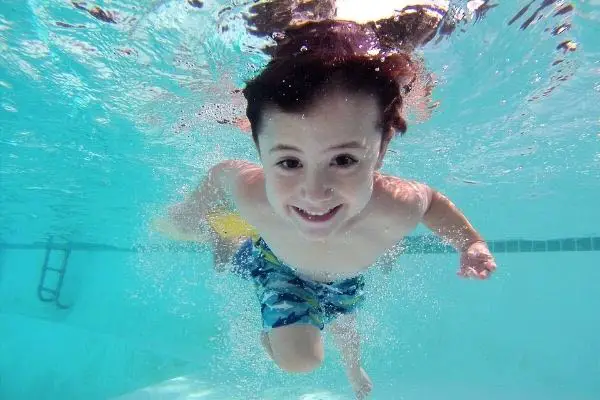boy swimming in a eco friendly pool