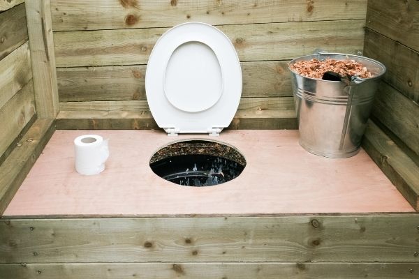 eco-friendly toilet with tissue and wood chips