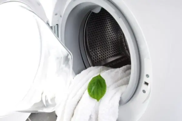 green leaf towel in laundry machine