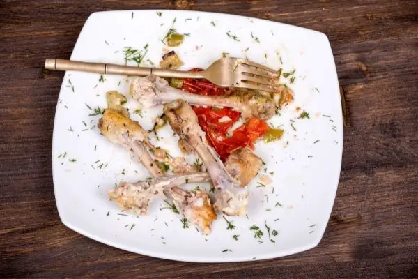 leftover chicken bones on a plate