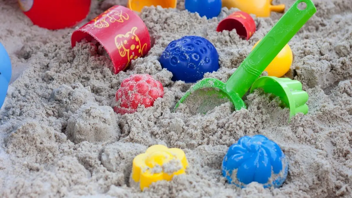 a sandbox with a bunch of colorful toys