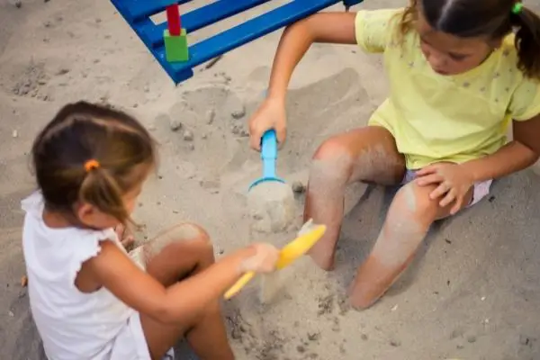 Girls Playing With Sand