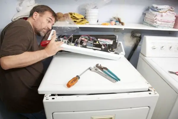 Man Repairing Clothes Dryer