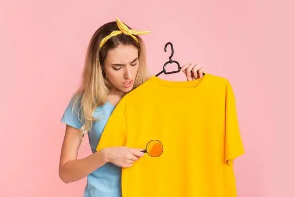 Mom looking at stain on yellow shirt
