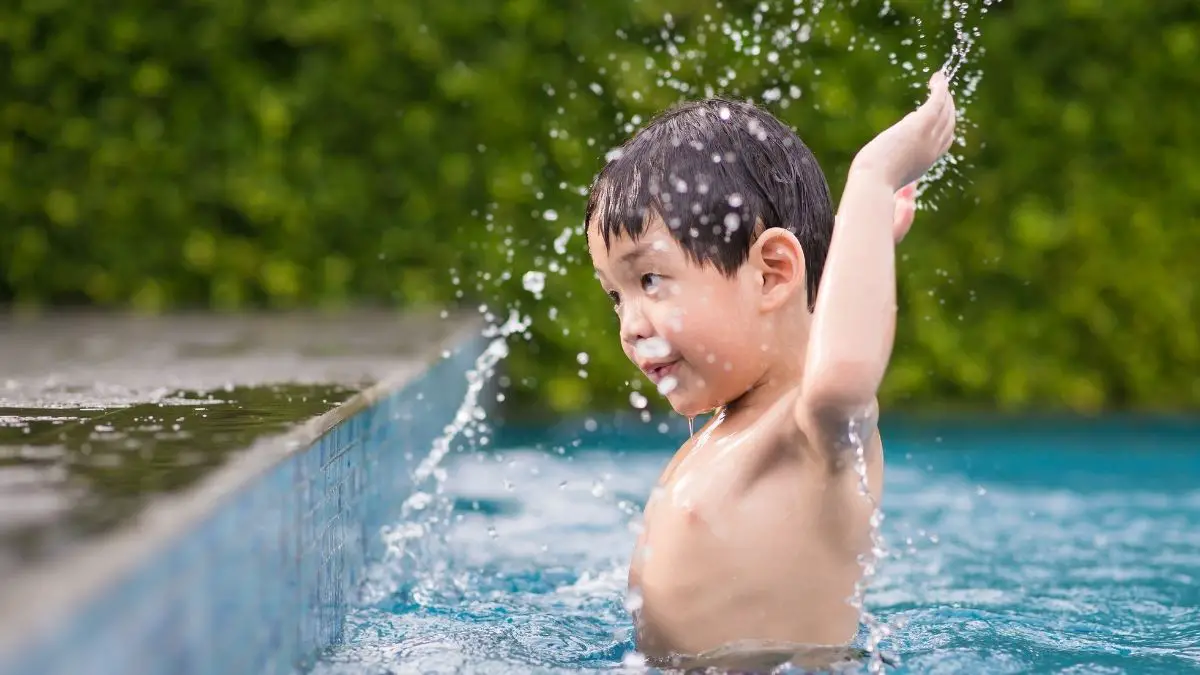 kid playing in a swimming pool