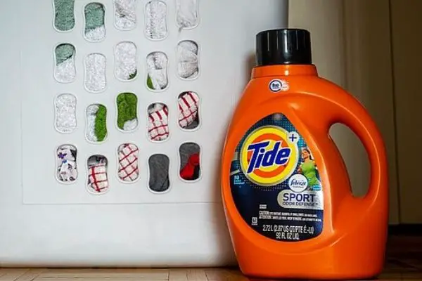 Tide Detergent Beside Laundry Basket