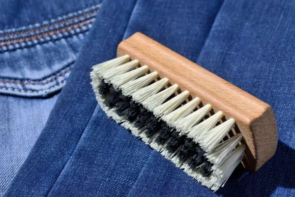 Cloth Brush On Top Of Blue Jeans