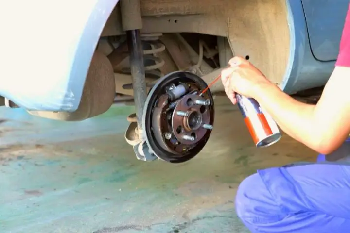 A Man Is Using A Brake Cleaner