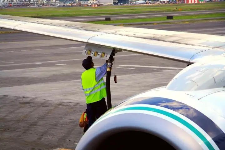A Man Refuels A Plane With Fuel
