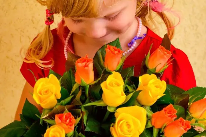 Girl Is Holding Flowers In Her Hands