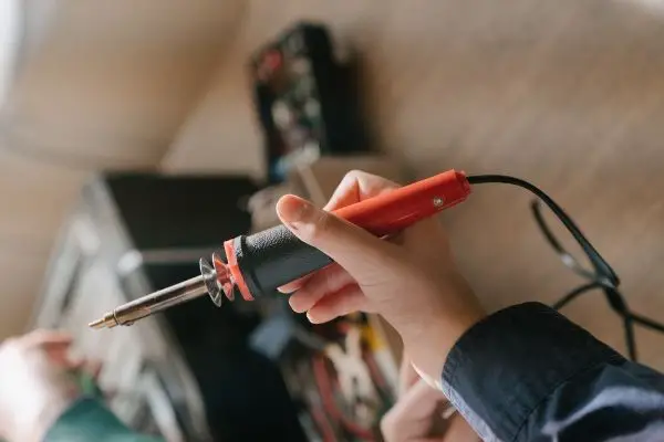 Person Holding Tool For Soldering