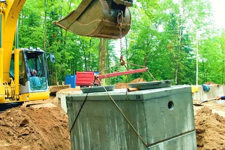 The Excavator Places The Septic Tank In The Pit