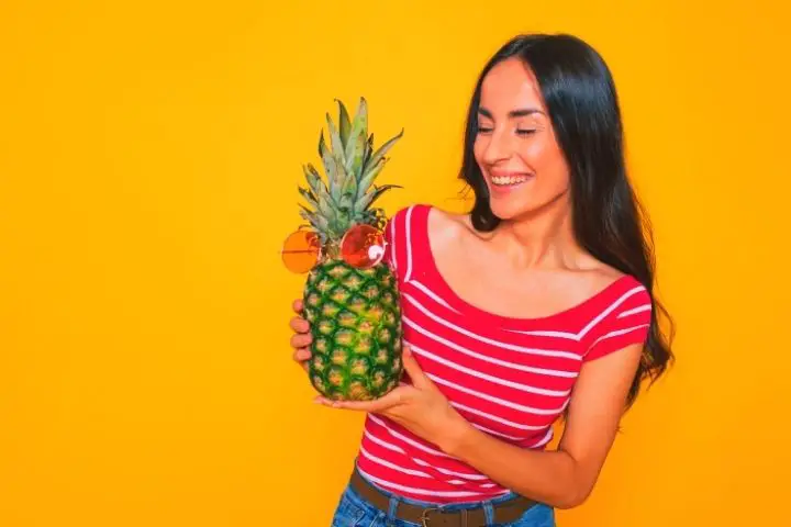 Woman Is Holding Pineapple In Her Hands