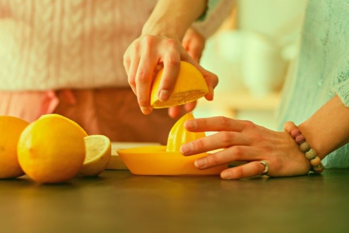 A Man Squeezes The Juice Out Of A Lemon