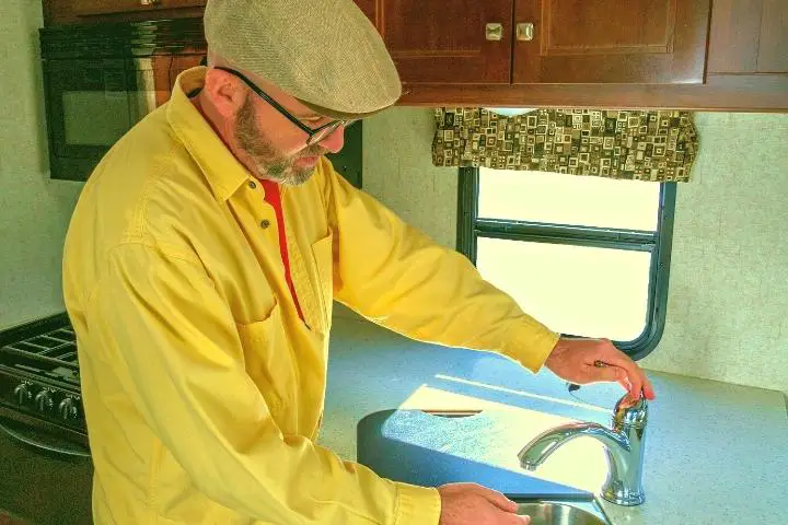Man Opens The Faucet In Rv