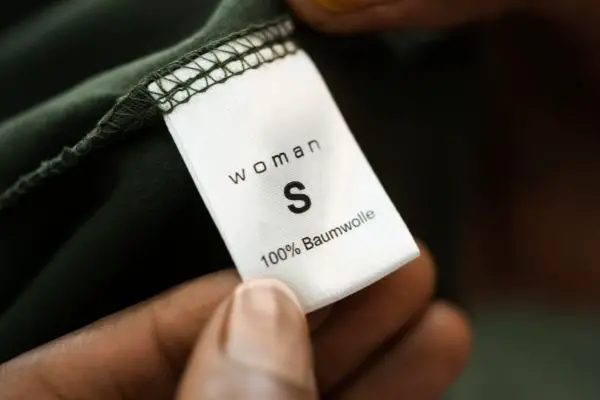 Person Holding Clothing Label