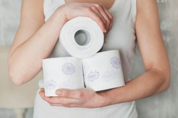 Woman Holding Rolls Of Toilet Paper