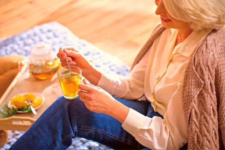 Woman Is Holding A Cup With Loose Leaf Tea