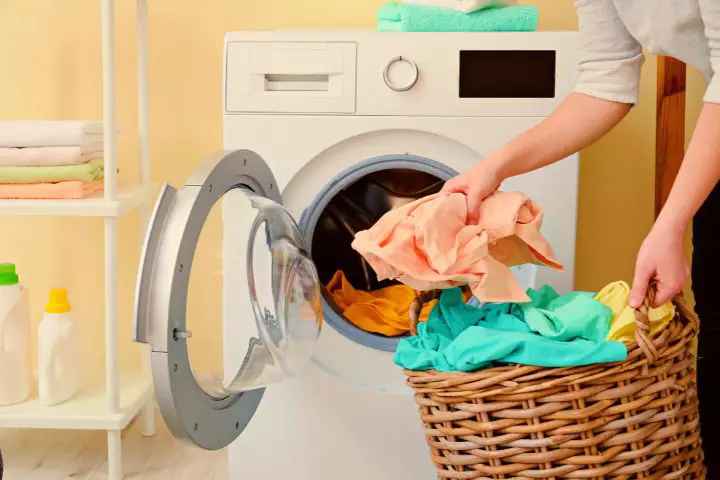 Woman Puts Clothes In Washing Machine