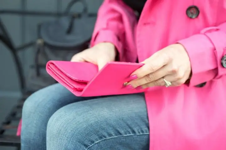 Woman Is Sitting And Holding Wallet 
