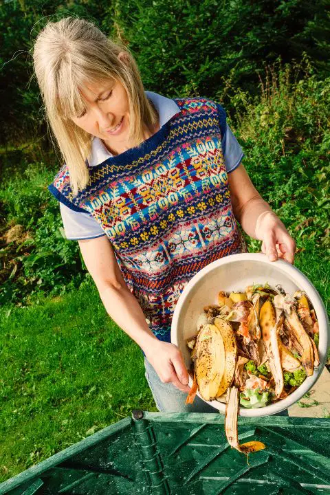 Woman With Compost In A Bowl