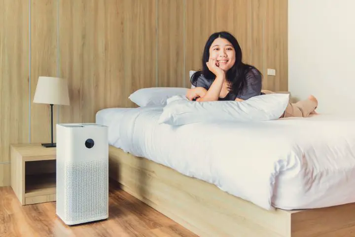 Air Purifier Next To Woman Laying On Bed
