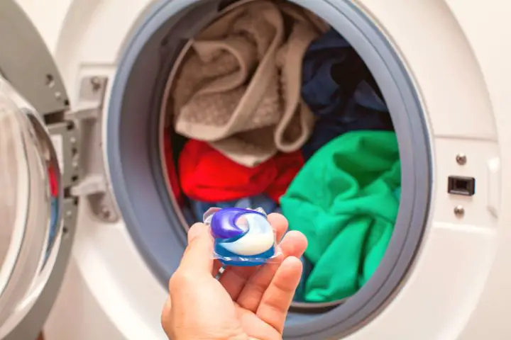 Man Puts Laundry Detergent In Washing Machine
