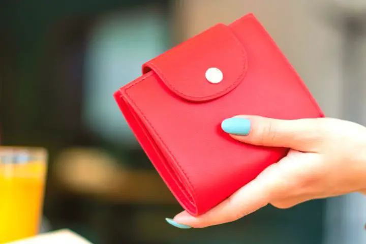 Red Wallet In A Womans Hand