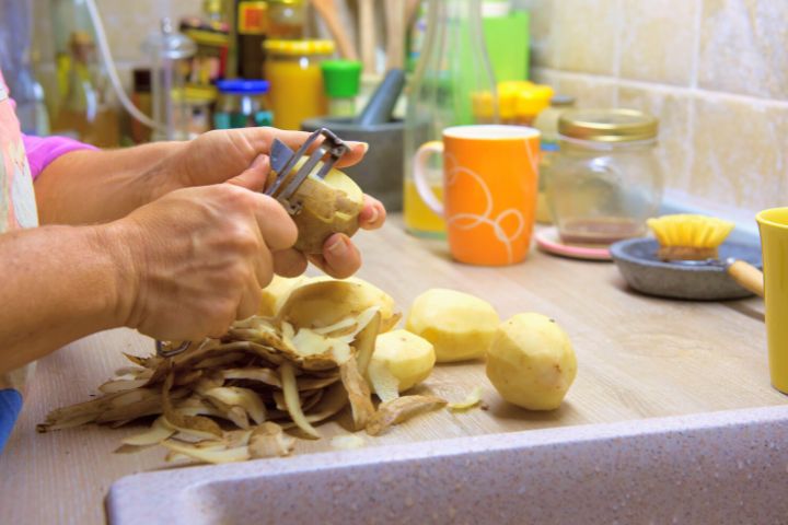 A Woman Peels Potatoes