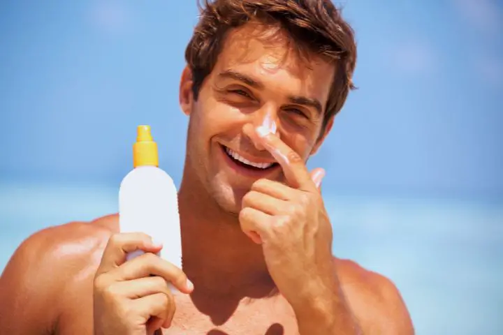 A Man Smears Himself With Sunscreen