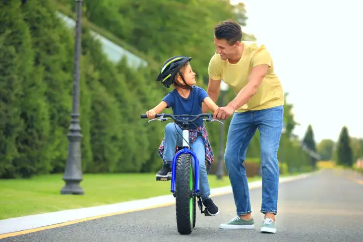 Dad Teaches His Son To Ride A Bike