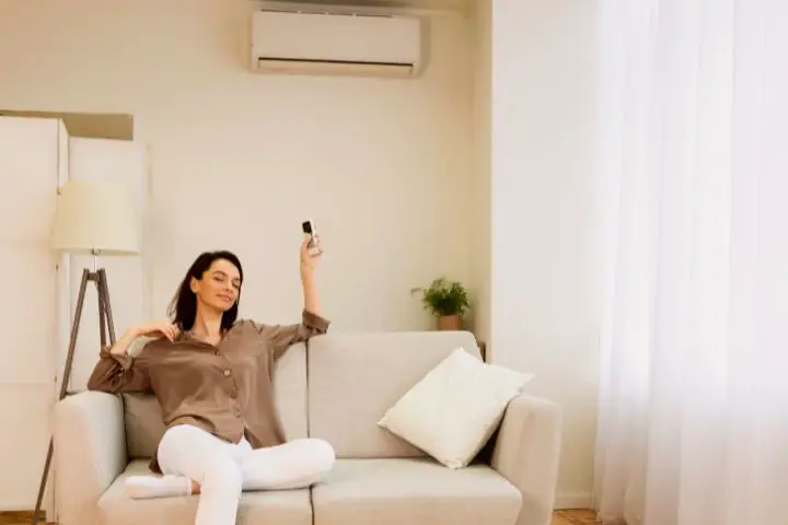 Woman Turns On The Air Conditioner