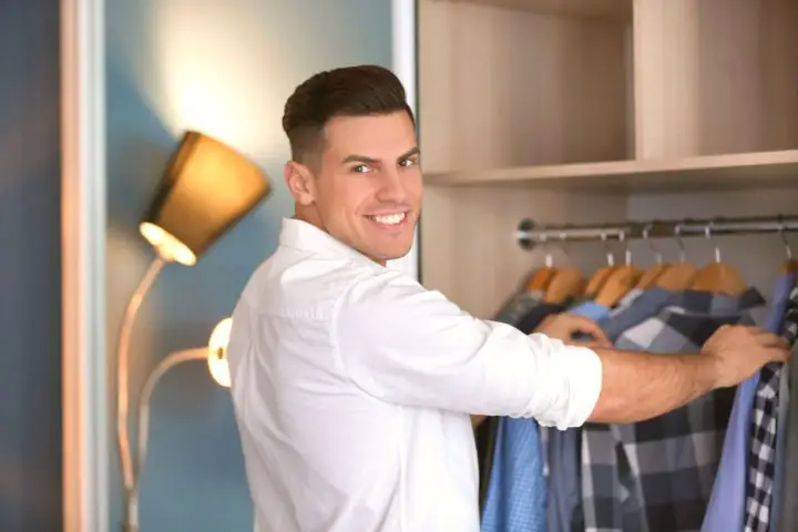 Man Looking For Shirt In Wardrobe