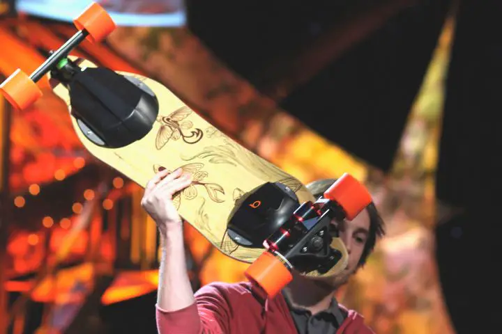 Man Keeps An Electric Skateboard Over Himself