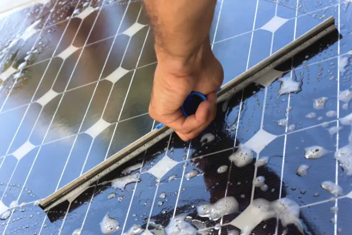 Man Washes Solar Panel