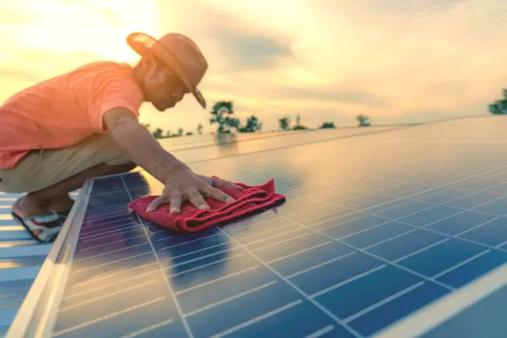 Man Wipes Solar Panel