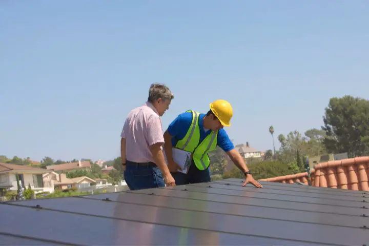 Workers Inspecting Solar Panels