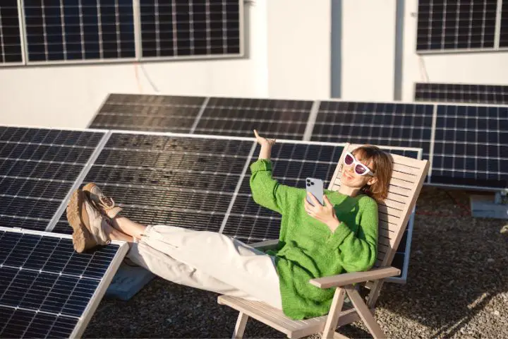 Happy Woman On Rooftop With A Solar Station